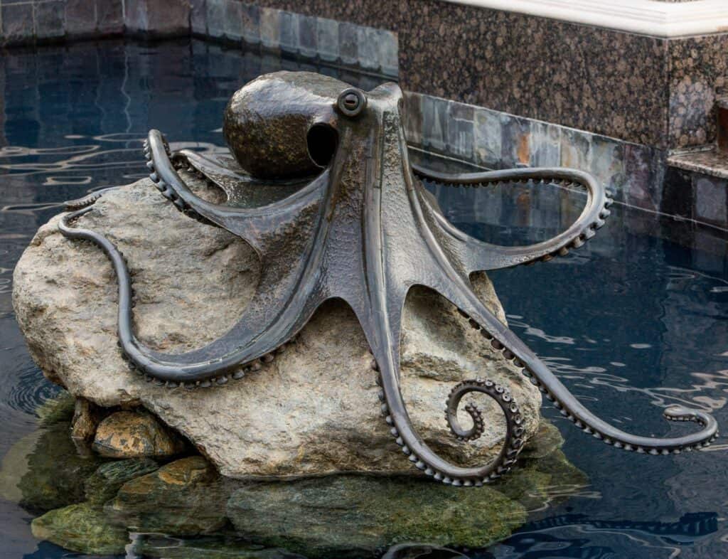 Metal octopus in the middle of pool