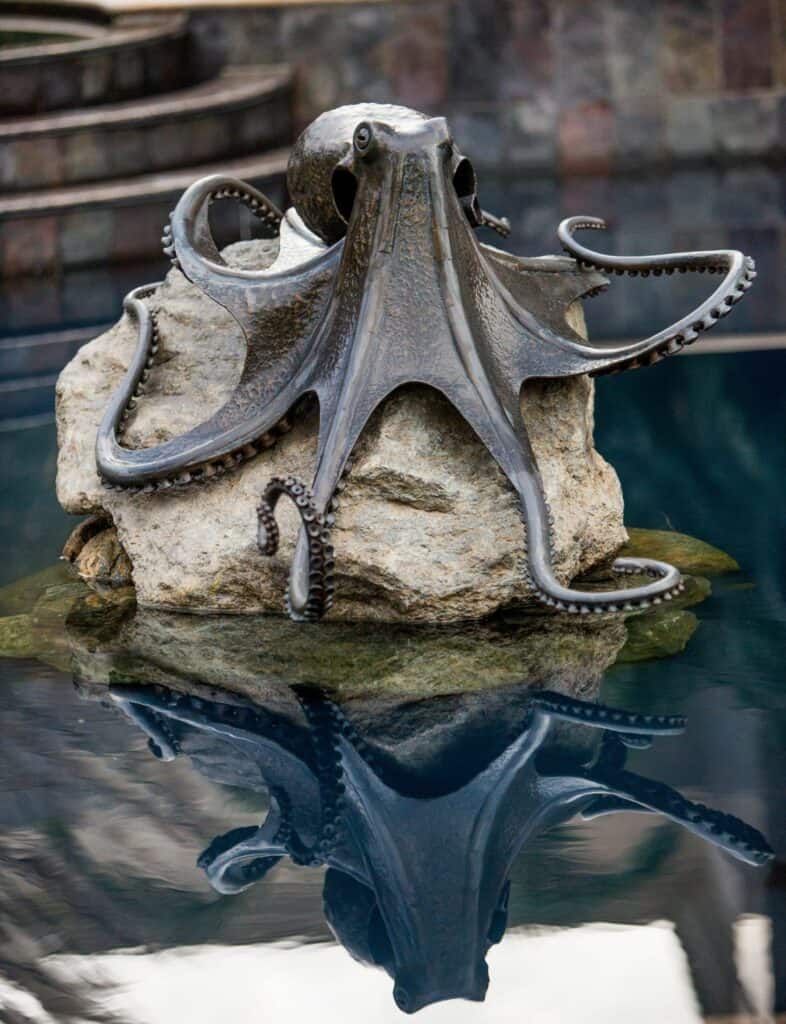 bronze metal octopus sculpture in pool