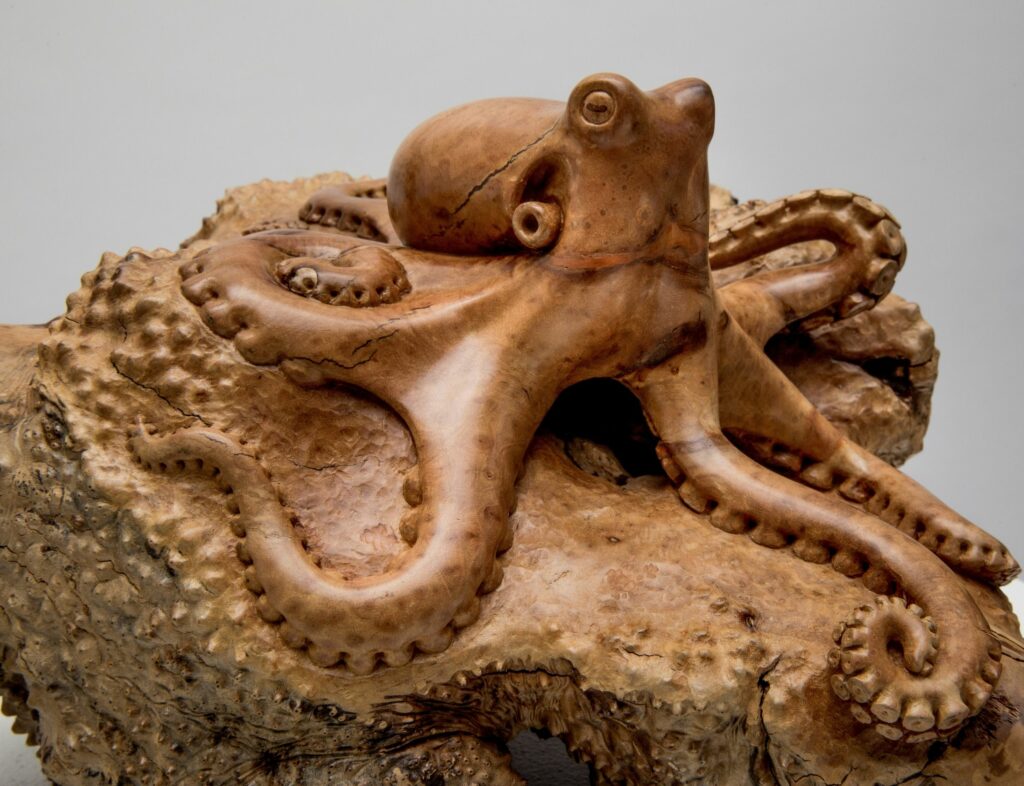 The wood octopus is carved out of a single piece of manzanita burl